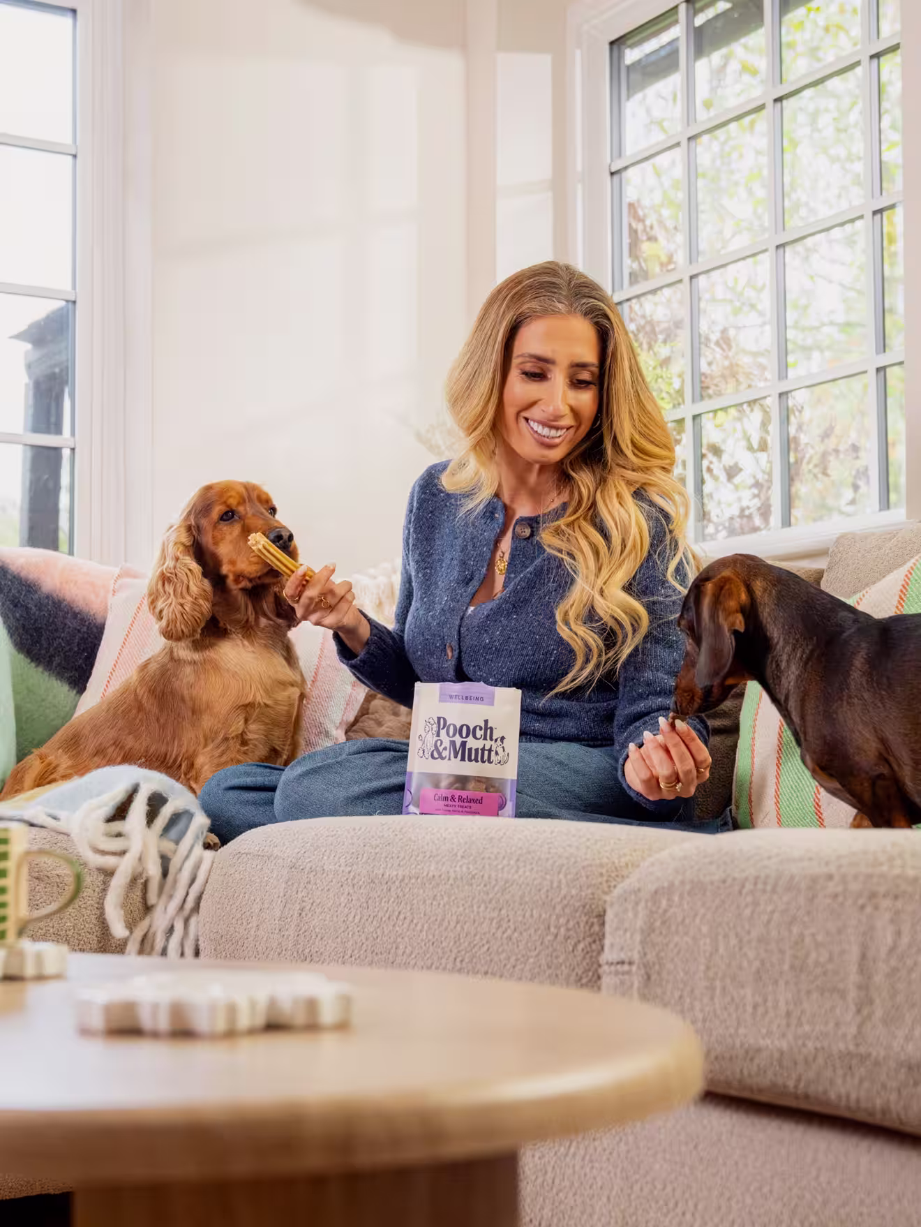 Stacey Solomon sits on the sofa with Peanut & Teddy